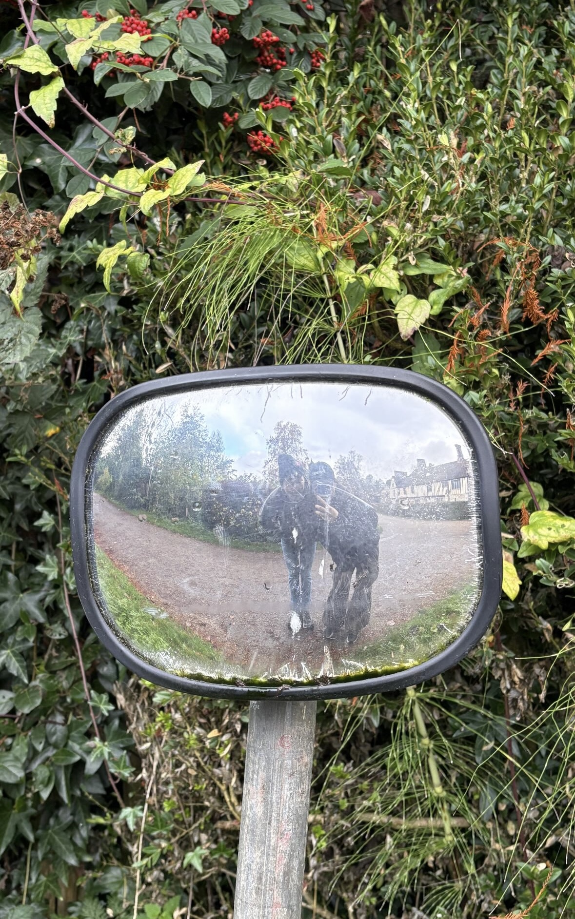 Hiking with a friend, reflected in a trail mirror